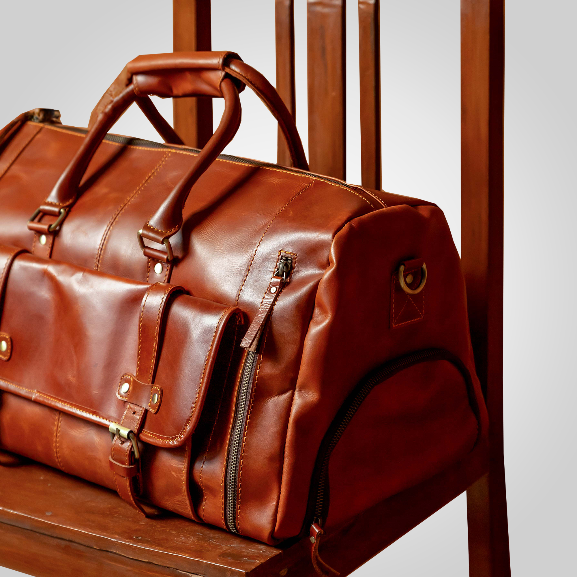 Close-up of The Escape full grain leather texture and premium brass hardware