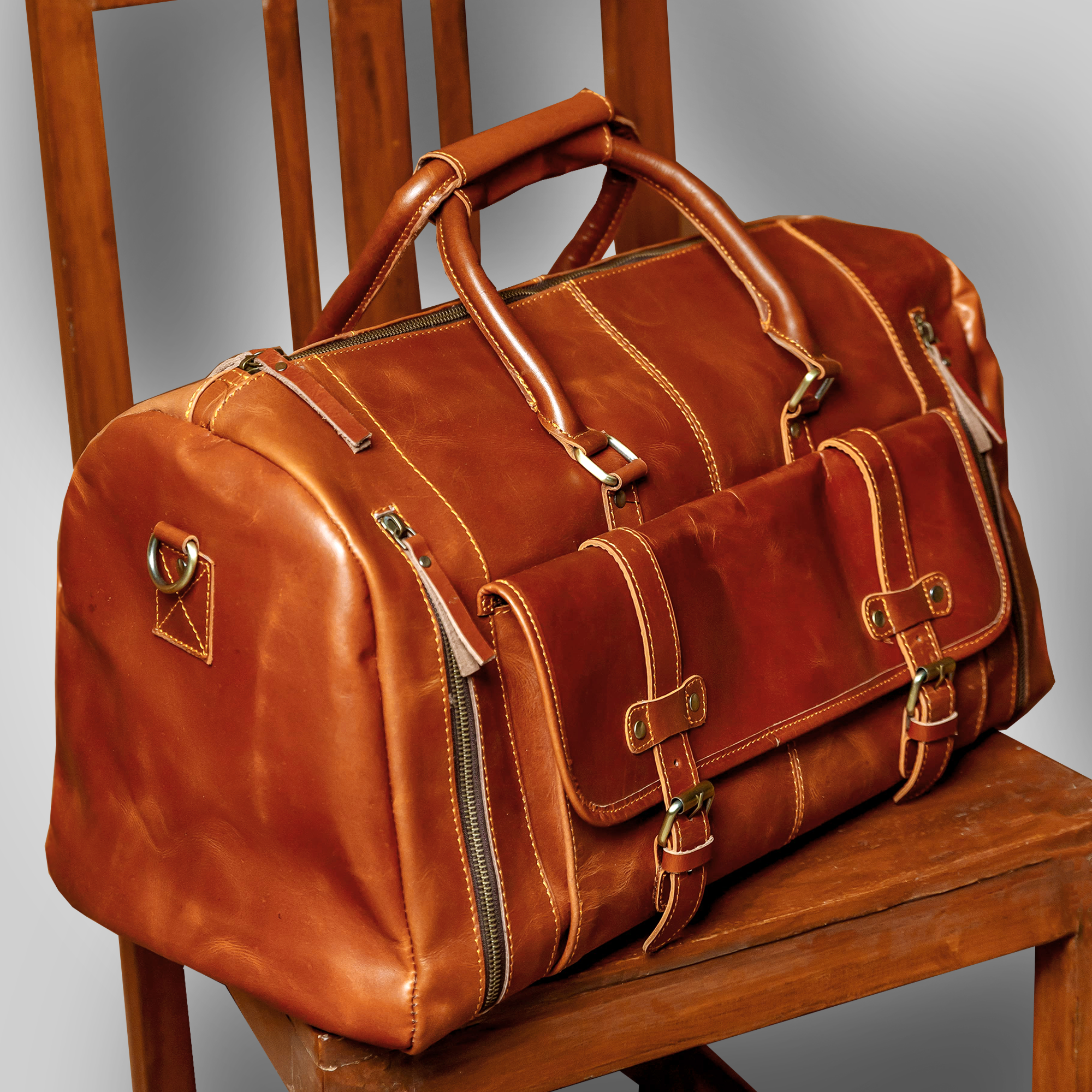 The Escape brown leather duffle bag placed on floor – timeless handcrafted design